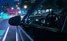 A car driving through a city at night