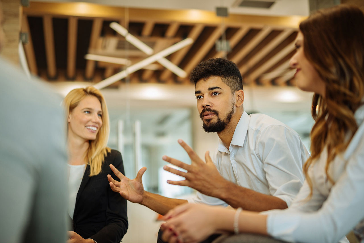 Man discussing and explaining to a group of people